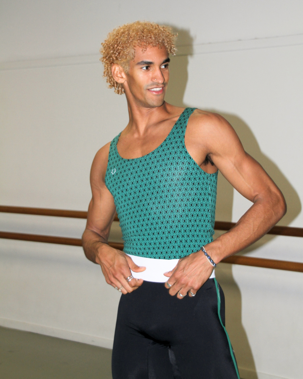 Davi Ramos wearing GENTS forest green print singlet in the studio